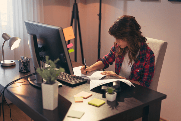 freelancer writing at a desk
