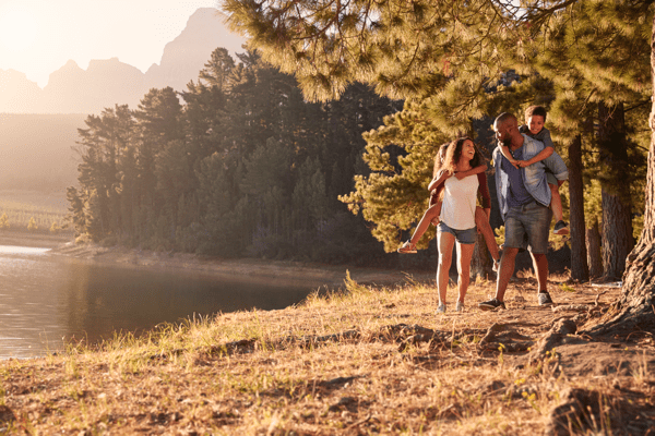 family hiking by a lake