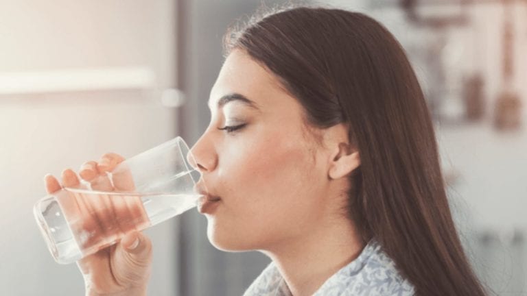 woman drinking a glass of water