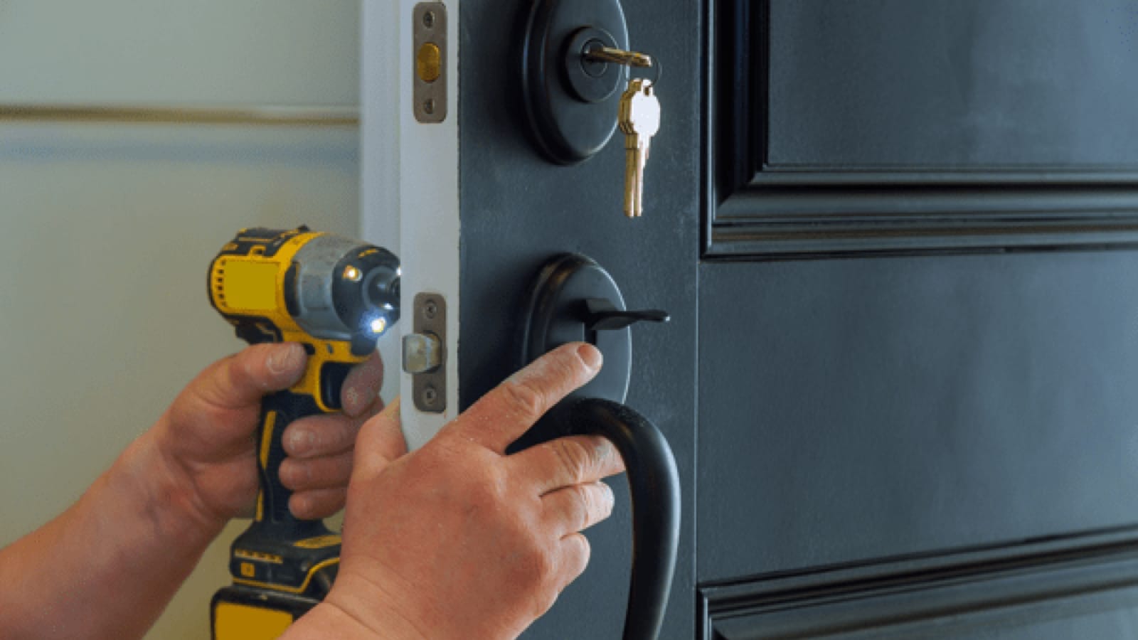 Homeowner adding a new deadbolt lock