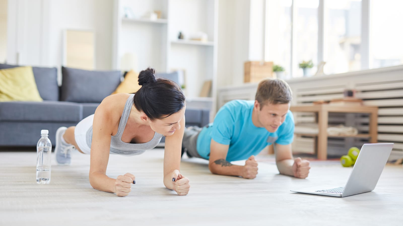 Couple watching a workout video in their living room