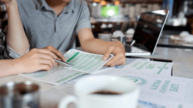 Person looking through life insurance documents