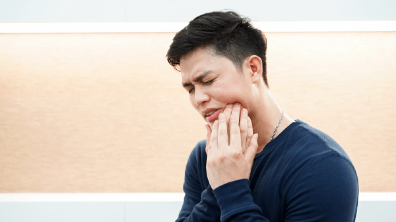 Man clutching his jaw in pain