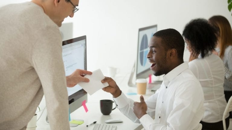 Employee getting handed a bonus at work