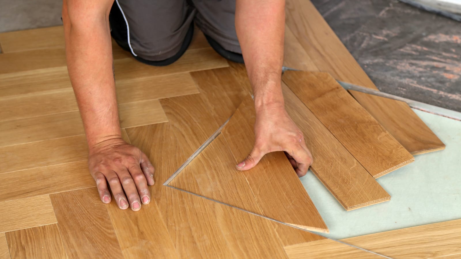 Man replacing the floorboards in a home