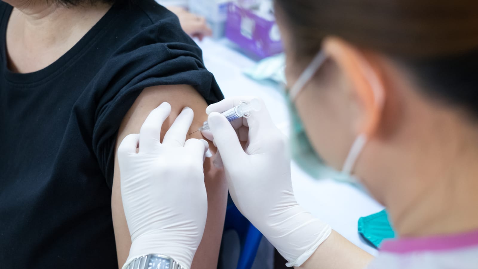 Woman receiving a flu shot in her arm