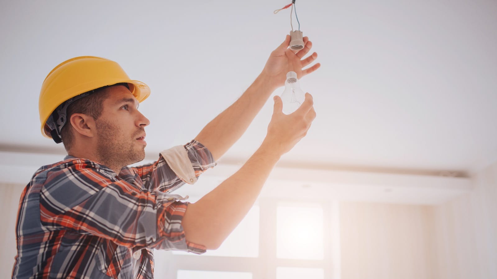 Contractor fixing a light