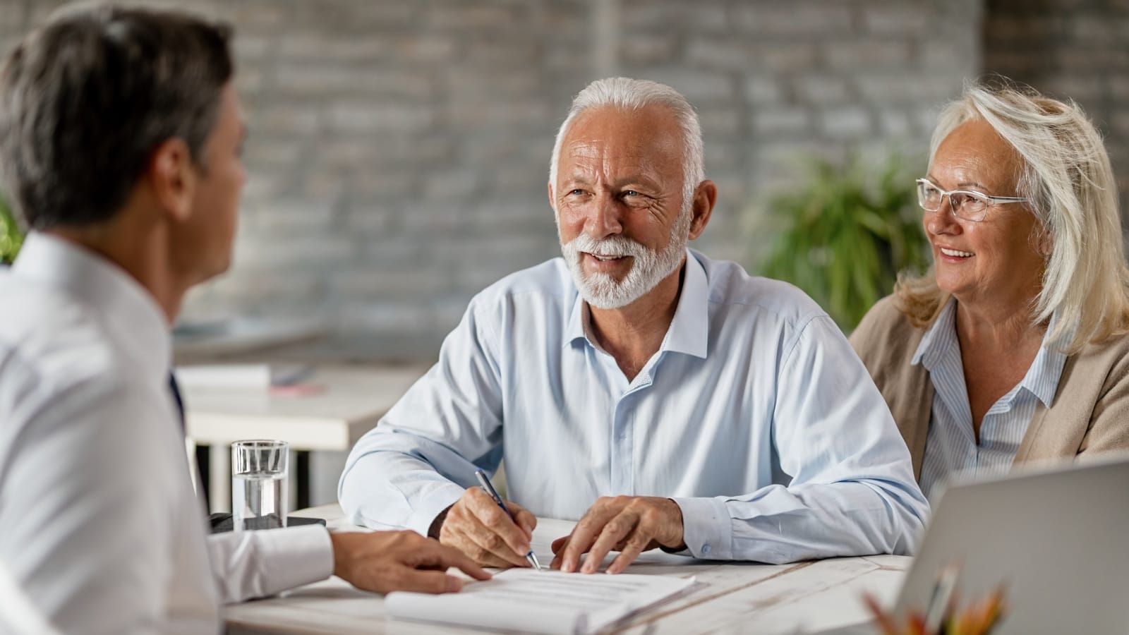 Seniors signing life insurance documents
