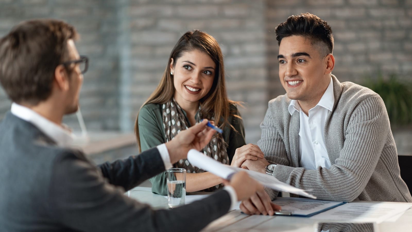 Young couple signing documents