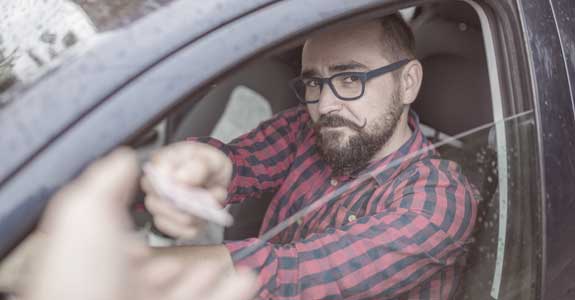 man_sitting_in_car_575x300