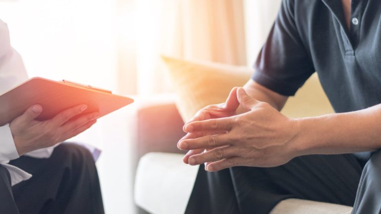 Man and doctor discussing cancer diagnosis