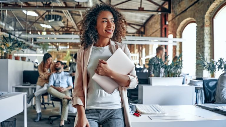 African American woman walking inside her business building