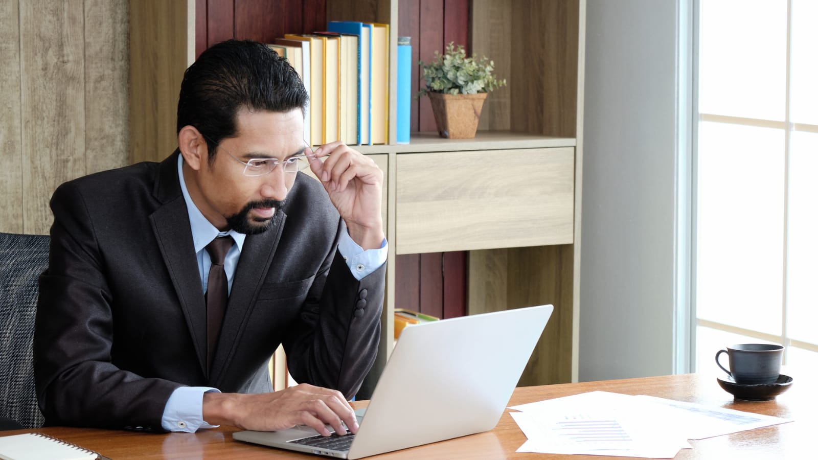 Businessman reviewing ICHRAs and QSEHRAs