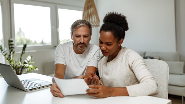 Mature couple reviewing supplemental health insurance options