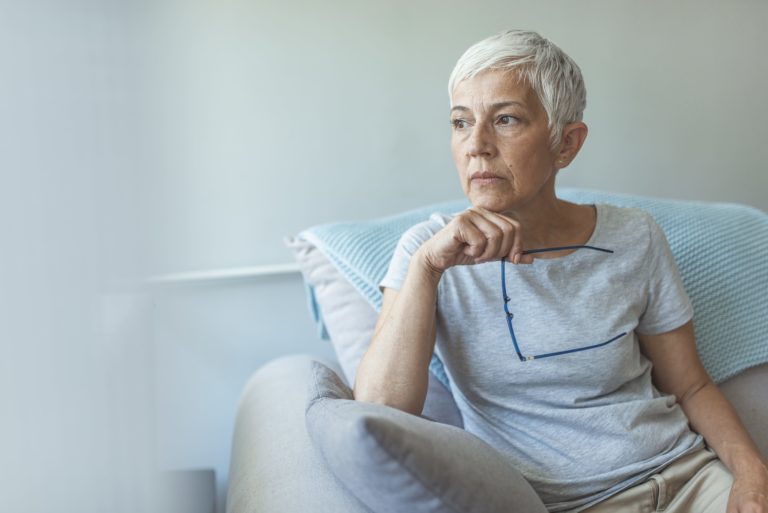 senior woman sitting on couch