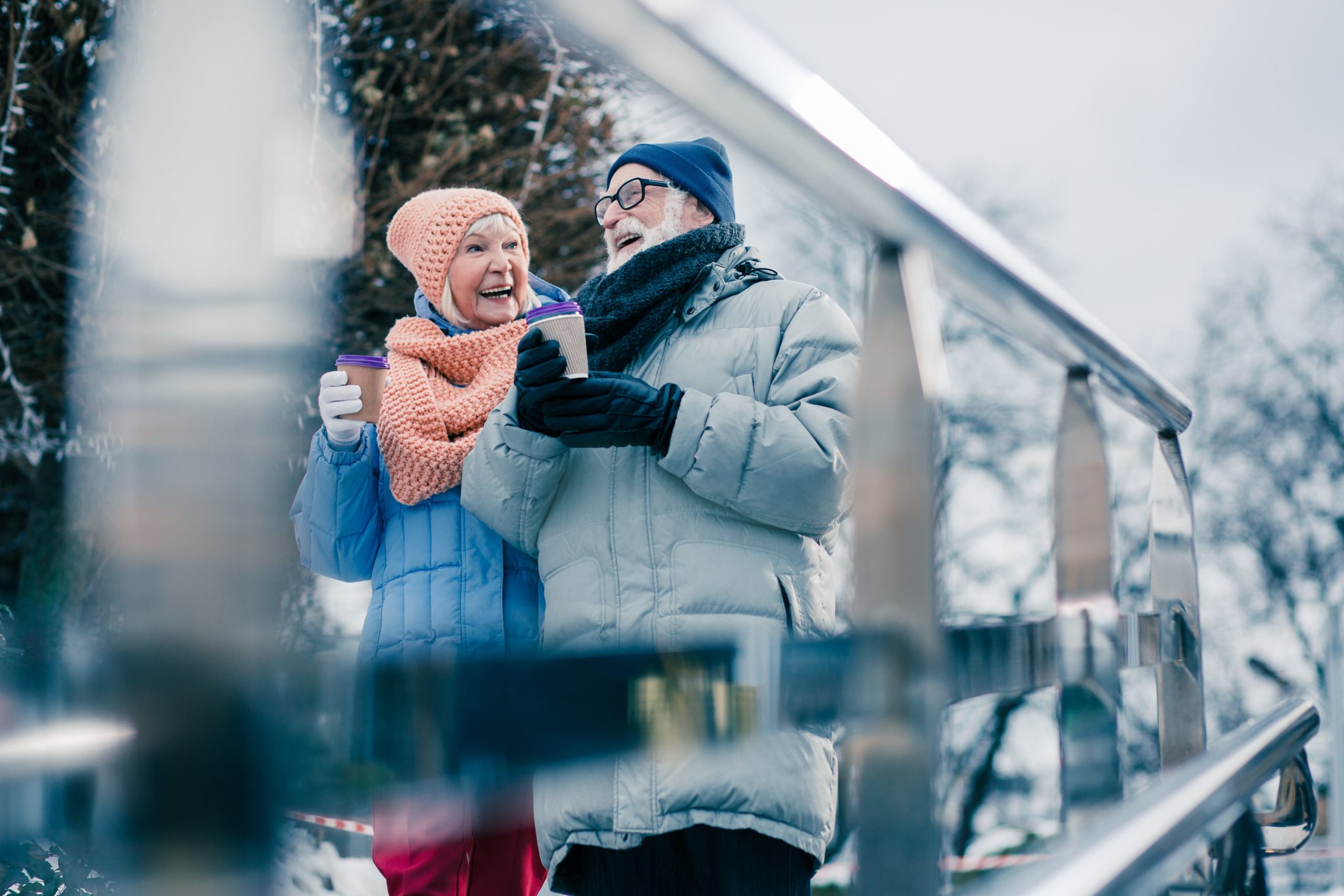 Senior Couple Holding Cup In The Winter