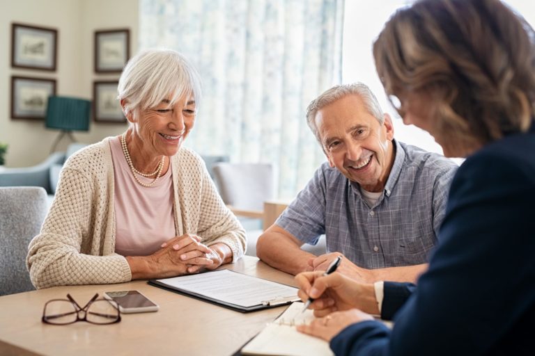 Happy Senior Couple Talking to Consultant