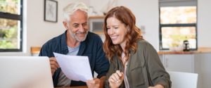 Young Woman and Older Man Reviewing Paperwork