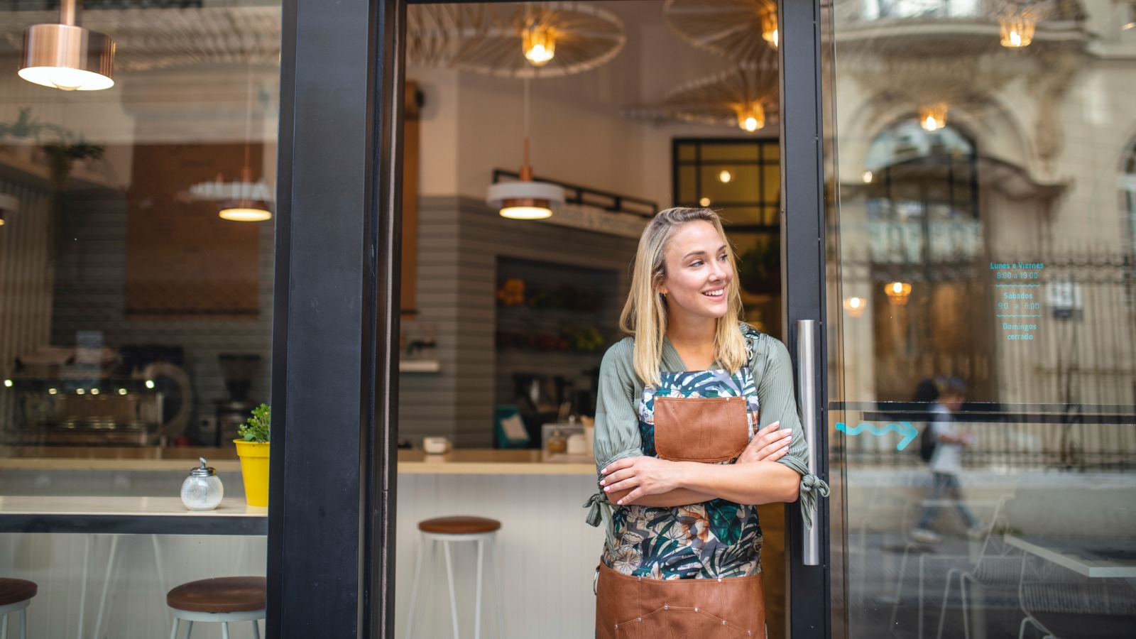 Woman standing outside of her cafe