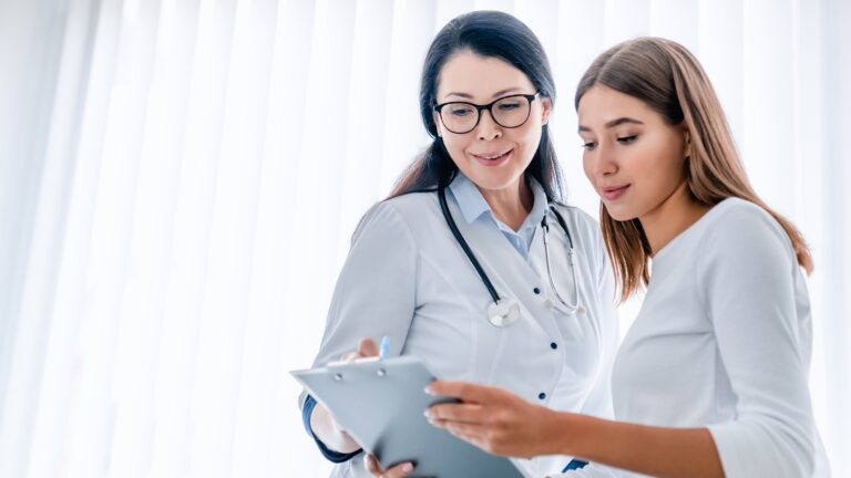 two women looking at medical records