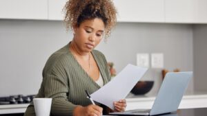 Woman looking through paperwork.