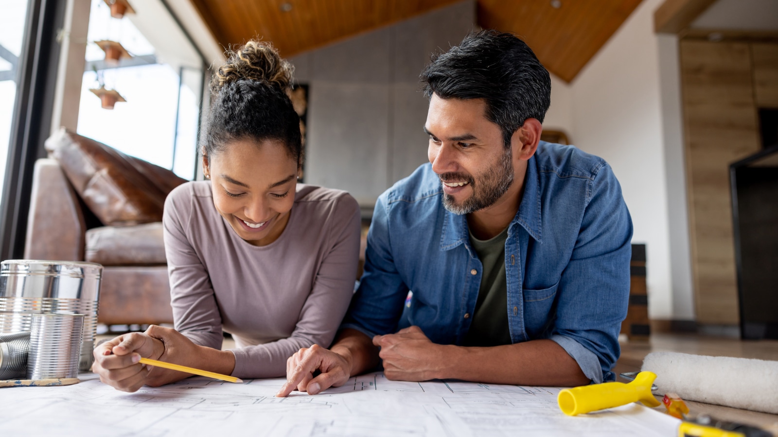 Young couple looking at home remodel plan.