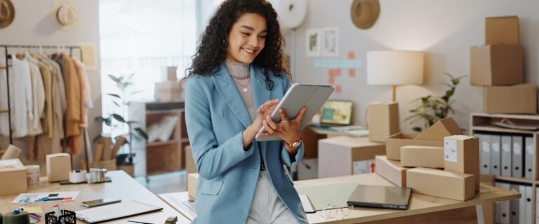 Young female business owner reading iPad.