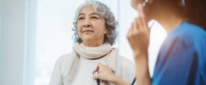 Older woman getting heart checked at wellness visit.