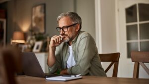 man reading on his laptop