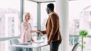 Co-workers shaking hands.