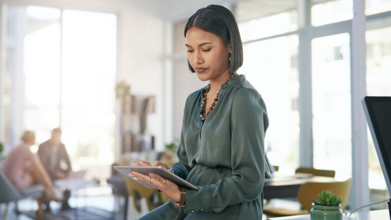 Young woman reading on ipad