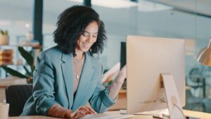 Young female business woman reading laptop
