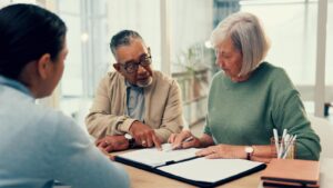 Older couple planning estate with life insurance agent.
