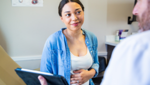 Young pregnant woman in hospital office.