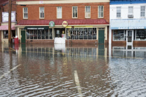 Flooded streets in front of business storefronts