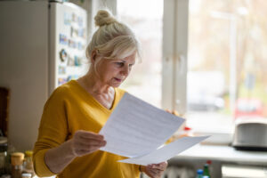 Senior woman filling out forms