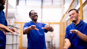 Warehouse employees dancing and laughing together